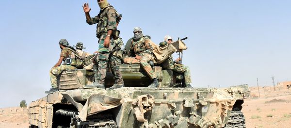 Members of the Syrian government forces ride on a tank, in the village of Kobajjep on the southwestern outskirts of Deir Ezzor province, on September 6, 2017, during the ongoing battle against Islamic State (IS) group jihadists. Members of the Syrian government forces ride on a tank, in the village of Kobajjep on the southwestern outskirts of Deir Ezzor province, on September 6, 2017, during the ongoing battle against Islamic State (IS) group jihadists. - Sputnik International