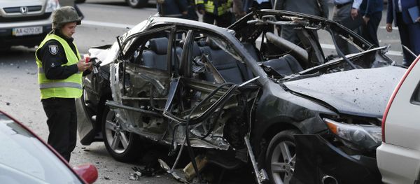 Investigators gather around a car, which was reportedly damaged by an explosion, in Kiev, Ukraine - Sputnik International