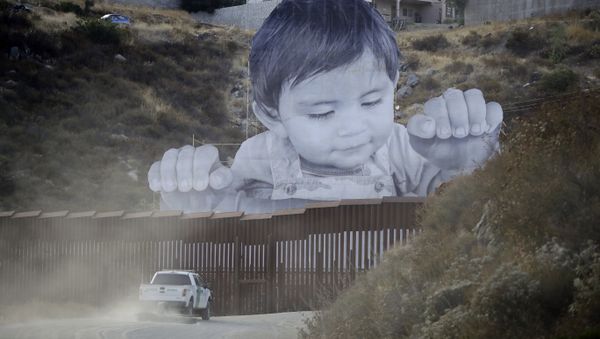 A Border Patrol vehicle drives in front of a mural in Tecate, Mexico, just beyond a border structure Friday, Sept. 8, 2017, in Tecate, Calif. A Border Patrol vehicle drives in front of a mural in Tecate, Mexico, just beyond a border structure Friday, Sept. 8, 2017, in Tecate, Calif. - Sputnik International