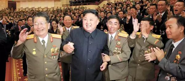 DPRK leader Kim Jong-un, flanked by the county's top nuclear-weapons officials, celebrates the country's weapons and ballistic missile achievements (KCNA image) - Sputnik International