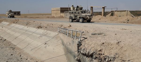 U.S. armored vehicles past near a destroyed bridge on a road that links to Raqqa city, northeast Syria. (File) U.S. armored vehicles past near a destroyed bridge on a road that links to Raqqa city, northeast Syria. (File) - Sputnik International