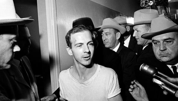 Surrounded by detectives, Lee Harvey Oswald talks to the press as he is led down a corridor of the Dallas police station for another round of questioning in connection with the assassination of US President John F. Kennedy, November 23, 1963. - Sputnik International
