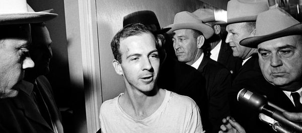 Surrounded by detectives, Lee Harvey Oswald talks to the press as he is led down a corridor of the Dallas police station for another round of questioning in connection with the assassination of US President John F. Kennedy, November 23, 1963. - Sputnik International