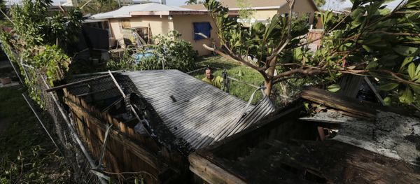 Bayardo Perez prepares to dismantle the mangled tin roof of his shed in Sweetwater, Fla., Monday, Sept. 11. - Sputnik International