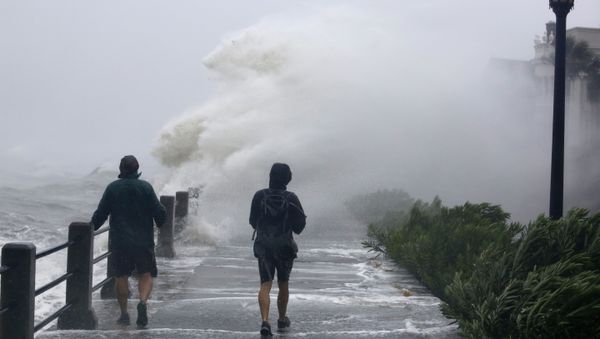 Pedestrians walk into huge waves crashing over The Battery as Tropical Storm Irma hits Charleston, S.C - Sputnik International