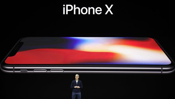 Apple CEO Tim Cook announces the new iPhone X at the Steve Jobs Theater on the new Apple campus, Tuesday, Sept. 12, 2017, in Cupertino, California. - Sputnik International