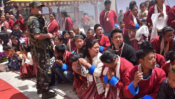 Buddhist followers wait for exiled Tibetan spiritual leader the Dalai Lama at Urgelling Monastery, the birthplace of the 6th Dalai Lama, in the district of Tawang in India's north-eastern state of Arunachal Pradesh on April 9, 2017 Buddhist followers wait for exiled Tibetan spiritual leader the Dalai Lama at Urgelling Monastery, the birthplace of the 6th Dalai Lama, in the district of Tawang in India's north-eastern state of Arunachal Pradesh on April 9, 2017 - Sputnik International