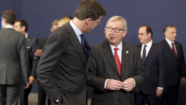 European Commission President Jean-Claude Juncker, center right, speaks with Dutch Prime Minister Mark Rutte during a group photo at an EU summit in Brussels on Thursday, Feb. 12, 2015. - Sputnik International