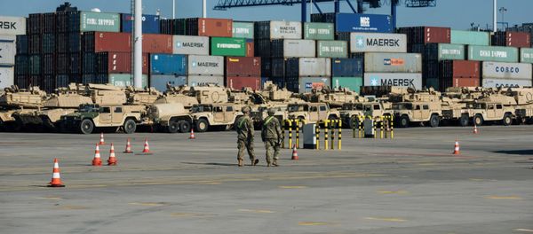 Soldiers walk near U.S. military equipment which arrived as part of NATO mission at port in Gdansk, Poland Soldiers walk near U.S. military equipment which arrived as part of NATO mission at port in Gdansk, Poland - Sputnik International