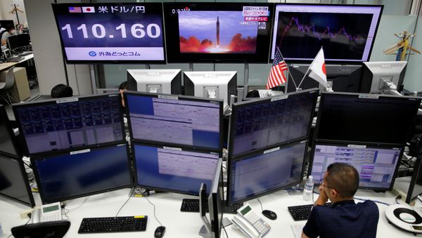 An employee of a foreign exchange trading company works in front of monitors showing TV news on North Korea's missile launch (top C) and the Japanese yen's exchange rate against the U.S. dollar (top L) in Tokyo, Japan, September 15, 2017 An employee of a foreign exchange trading company works in front of monitors showing TV news on North Korea's missile launch (top C) and the Japanese yen's exchange rate against the U.S. dollar (top L) in Tokyo, Japan, September 15, 2017 - Sputnik International