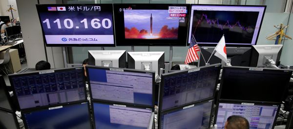 An employee of a foreign exchange trading company works in front of monitors showing TV news on North Korea's missile launch (top C) and the Japanese yen's exchange rate against the U.S. dollar (top L) in Tokyo, Japan, September 15, 2017 An employee of a foreign exchange trading company works in front of monitors showing TV news on North Korea's missile launch (top C) and the Japanese yen's exchange rate against the U.S. dollar (top L) in Tokyo, Japan, September 15, 2017 - Sputnik International