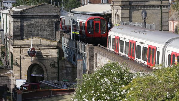 Members of the emergency services work alongside an underground tube train at a platform at Parsons Green underground tube station in west London on September 15, 2017, following an incident on an underground tube carriage at the station Members of the emergency services work alongside an underground tube train at a platform at Parsons Green underground tube station in west London on September 15, 2017, following an incident on an underground tube carriage at the station - Sputnik International