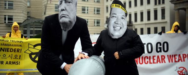 Activists of the non-governmental organization International Campaign to Abolish Nuclear Weapons (ICAN) wear masks of US President Donal Trump and leader of the Democratic People's Republic of Korea Kim Jon-un while posing with a mock missile in front of the embassy of Democratic People's Republic of Korea in Berlin, on September 13, 2017 - Sputnik International