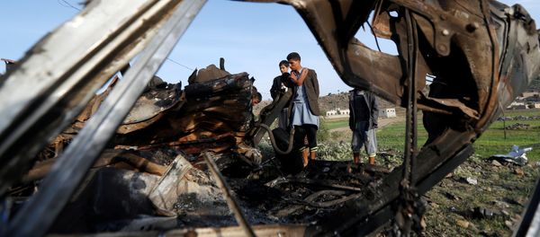 People look at the wreckage of a taxi car destroyed by a Saudi-led air strike on a checkpoint of the armed Houthi movement near Sanaa, Yemen August 30, 2017 People look at the wreckage of a taxi car destroyed by a Saudi-led air strike on a checkpoint of the armed Houthi movement near Sanaa, Yemen August 30, 2017 - Sputnik International