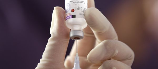 A health official prepares one of many vaccine injections. A health official prepares one of many vaccine injections. - Sputnik International