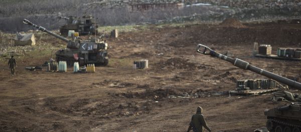 Israeli soldiers walk next to mobile artillery units in the Israeli-occupied Golan Heights near the border with Syria. (File) Israeli soldiers walk next to mobile artillery units in the Israeli-occupied Golan Heights near the border with Syria. (File) - Sputnik International