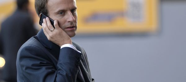 French Economy and Industry minister Emmanuel Macron gives a phone as he visits the 2014 Paris Auto Show on October 3, 2014 in Paris on the second of the two press days. French Economy and Industry minister Emmanuel Macron gives a phone as he visits the 2014 Paris Auto Show on October 3, 2014 in Paris on the second of the two press days. - Sputnik International