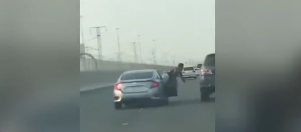 Road rage passenger hangs out of moving car and 'tries to punch' 4X4 driver - before getting instant Road rage passenger hangs out of moving car and 'tries to punch' 4X4 driver - before getting instant - Sputnik International