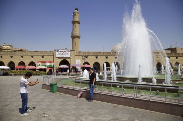 In this Thursday, Aug. 24, 2017 photo, young men take pictures outside Irbil’s citadel in front of a poster urging people to vote yes in the upcoming poll on Kurdish independence from Iraq - Sputnik International
