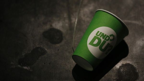 A paper cup with the election campaign logo of the German Green Party that reads And you , lies on the ground after a party leader's press conference in Berlin, Germany, on September 23, 2013, a day after the German general elections. A paper cup with the election campaign logo of the German Green Party that reads And you , lies on the ground after a party leader's press conference in Berlin, Germany, on September 23, 2013, a day after the German general elections. - Sputnik International