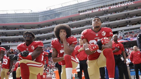 from left, San Francisco 49ers outside linebacker Eli Harold, quarterback Colin Kaepernick and safety Eric Reid kneel during the national anthem before an NFL football game against the Dallas Cowboys in Santa Clara, Calif. Since Kaepernick announced he would not stand for the song in protest of racial discrimination against blacks in the United States, many performers are now rethinking offers to sing the national anthem. - Sputnik International