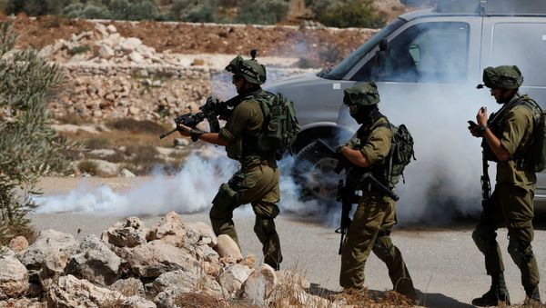 Israeli soldiers fire tear gas canisters at Palestinians during clashes following a protest against closure of a road south of the West Bank city of Hebron September 22, 2017 Israeli soldiers fire tear gas canisters at Palestinians during clashes following a protest against closure of a road south of the West Bank city of Hebron September 22, 2017 - Sputnik International