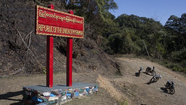 Motorcycles stand beside a sign on the border between Myanmar and India at Pangsau Pass, Saigang State, Northern Myanmar. (File) Motorcycles stand beside a sign on the border between Myanmar and India at Pangsau Pass, Saigang State, Northern Myanmar. (File) - Sputnik International