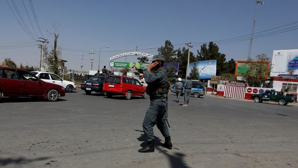 Afghan policemen stand guard outside of Kabul Airport after rockets exploded in Kabul, Afghanistan - Sputnik International