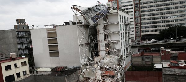 A photojournalist (R) takes a picture of a collapsed building, after an earthquake in Mexico City, Mexico September 28, 2017 - Sputnik International