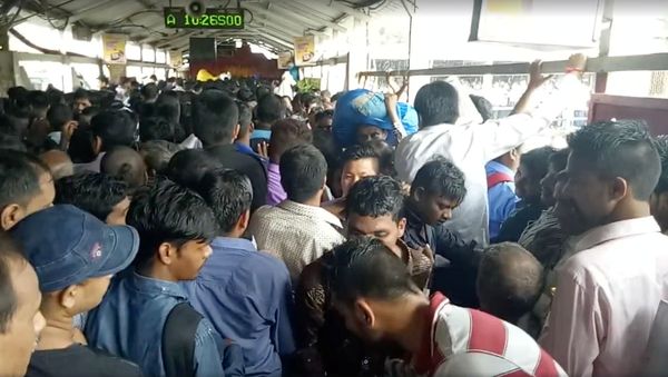 Crowds of commuters are seen moving along the Elphinstone railway station bridge around the time of a stampede, in Mumbai, India Crowds of commuters are seen moving along the Elphinstone railway station bridge around the time of a stampede, in Mumbai, India - Sputnik International