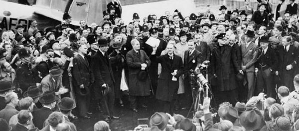 Neville Chamberlain holding the paper containing the resolution to commit to peaceful methods signed by both Hitler and himself on his return from Munich. He is showing the piece of paper to a crowd at Heston Aerodrome on 30 September 1938 Neville Chamberlain holding the paper containing the resolution to commit to peaceful methods signed by both Hitler and himself on his return from Munich. He is showing the piece of paper to a crowd at Heston Aerodrome on 30 September 1938 - Sputnik International