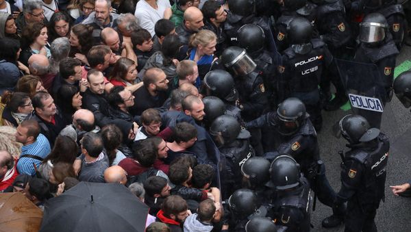 Riot police face off with demonstrators outside a polling station for the banned independence referendum in Barcelona, Spain, October 1, 2017 - Sputnik International