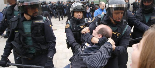 Spanish Guardia Civil guards drag a man outside a polling station in Sant Julia de Ramis, where Catalan president was supposed to vote, on October 1, 2017, on the day of a referendum on independence for Catalonia banned by Madrid Spanish Guardia Civil guards drag a man outside a polling station in Sant Julia de Ramis, where Catalan president was supposed to vote, on October 1, 2017, on the day of a referendum on independence for Catalonia banned by Madrid - Sputnik International