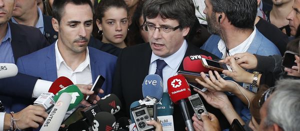 Catalan President Carles Puigdemont, centre, speaks to the media at a sports center, assigned to be a polling station by the Catalan government and where Puigdemont was originally expected to vote, in Sant Julia de Ramis, near Girona, Spain, Sunday, Oct. 1, 2017. Scuffles earlier erupted as voters protested as dozens of anti-rioting police broke into a polling station. Catalan President Carles Puigdemont, centre, speaks to the media at a sports center, assigned to be a polling station by the Catalan government and where Puigdemont was originally expected to vote, in Sant Julia de Ramis, near Girona, Spain, Sunday, Oct. 1, 2017. Scuffles earlier erupted as voters protested as dozens of anti-rioting police broke into a polling station. - Sputnik International
