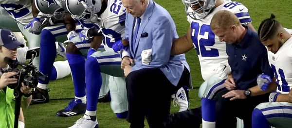 In this Monday, Sept. 25, 2017, file photo, the Dallas Cowboys, led by owner Jerry Jones, center, take a knee prior to the national anthem before an NFL football game against the Arizona Cardinals in Glendale, Ariz. What began more than a year ago with a lone NFL quarterback protesting police brutality against minorities by kneeling silently during the national anthem before games has grown into a roar with hundreds of players sitting, kneeling, locking arms or remaining in locker rooms, their reasons for demonstrating as varied as their methods. - Sputnik International