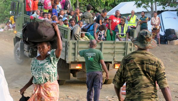 their possessions as they prepare to board a boat at Lolowai Port as they evacuate due to the Manaro Voui volcano continuing to emenate smoke and ash on Vanuatu's northern island of Ambae in the South Pacific, October 1, 2017 - Sputnik International