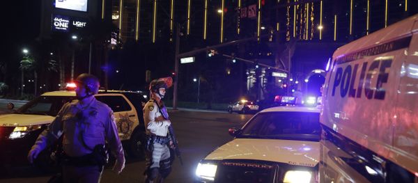 Police officers stand along the Las Vegas Strip outside the Mandalay Bay resort and casino during a deadly shooting near the casino, Sunday, Oct. 1, 2017, in Las Vegas Police officers stand along the Las Vegas Strip outside the Mandalay Bay resort and casino during a deadly shooting near the casino, Sunday, Oct. 1, 2017, in Las Vegas - Sputnik International