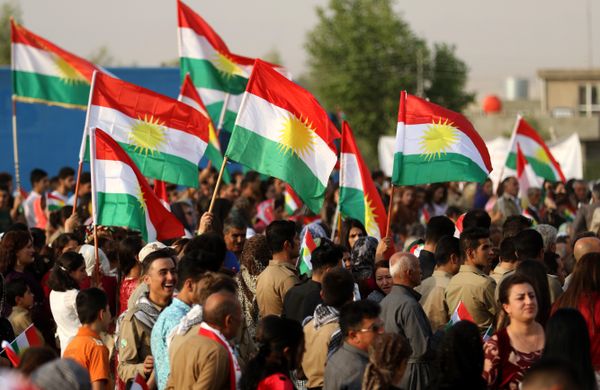 Iranian Kurds hold Kurdish flags as they take part in a gathering to urge people to vote in the independence referendum in the town of Bahirka, north of Arbil, the capital of the autonomous Kurdish region of northern Iraq. - Sputnik International