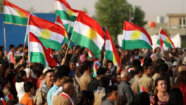 Iranian Kurds hold Kurdish flags as they take part in a gathering to urge people to vote in the independence referendum in the town of Bahirka, north of Arbil, the capital of the autonomous Kurdish region of northern Iraq. Iranian Kurds hold Kurdish flags as they take part in a gathering to urge people to vote in the independence referendum in the town of Bahirka, north of Arbil, the capital of the autonomous Kurdish region of northern Iraq. - Sputnik International
