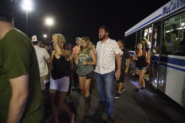 People arrive to Thomas & Mack Center via bus after hiding inside the Sands Corporation plane hangar after a mass shooting in which dozens were killed at the Route 91 Harvest country festival on early Monday, Oct. 2, 2017, in Las Vegas - Sputnik International