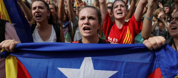 A woman holds up an Estelada (Catalan separatist flag) during a protest one day after the banned independence referendum in Barcelona, Spain A woman holds up an Estelada (Catalan separatist flag) during a protest one day after the banned independence referendum in Barcelona, Spain - Sputnik International