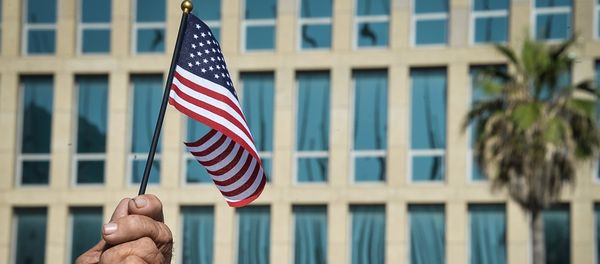 A Cuban holds a little US flag in front of the US Embassy in Havana. (File) A Cuban holds a little US flag in front of the US Embassy in Havana. (File) - Sputnik International