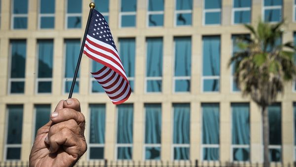 A Cuban holds a little US flag in front of the US Embassy in Havana. (File) A Cuban holds a little US flag in front of the US Embassy in Havana. (File) - Sputnik International