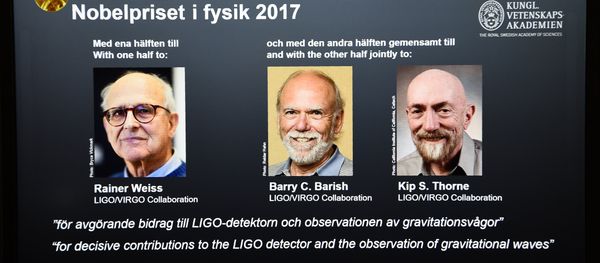 Laureates (L-R) Rainer Weiss, Barry C Barish and Kip S Thorne are pictured on a display during the announcement of the 2017 Nobel Prize winners in Physics on October 3, 2017, at the Royal Swedish Academy of Sciences in Stockholm - Sputnik International