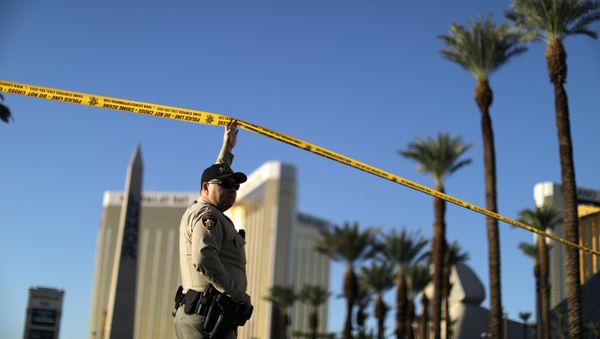 A police officer stands in front of the closed Las Vegas Strip next to the site of the Route 91 music festival mass shooting outside the Mandalay Bay Resort and Casino in Las Vegas, Nevada, U.S A police officer stands in front of the closed Las Vegas Strip next to the site of the Route 91 music festival mass shooting outside the Mandalay Bay Resort and Casino in Las Vegas, Nevada, U.S - Sputnik International