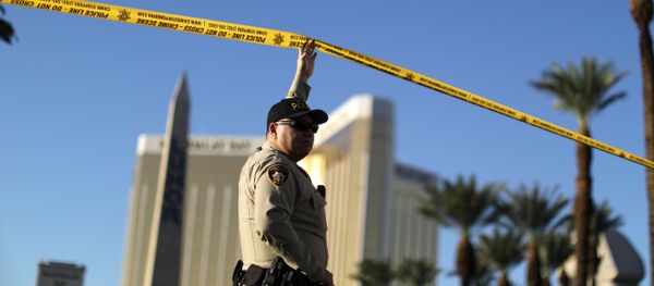 A police officer stands in front of the closed Las Vegas Strip next to the site of the Route 91 music festival mass shooting outside the Mandalay Bay Resort and Casino in Las Vegas, Nevada, U.S A police officer stands in front of the closed Las Vegas Strip next to the site of the Route 91 music festival mass shooting outside the Mandalay Bay Resort and Casino in Las Vegas, Nevada, U.S - Sputnik International