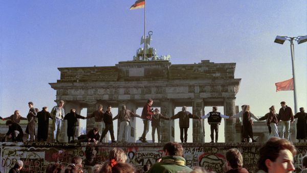 Berliners sing and dance on top of the Berlin Wall to celebrate the opening of East-West German borders, Friday afternoon, Nov. 10, 1989. Berliners sing and dance on top of the Berlin Wall to celebrate the opening of East-West German borders, Friday afternoon, Nov. 10, 1989. - Sputnik International