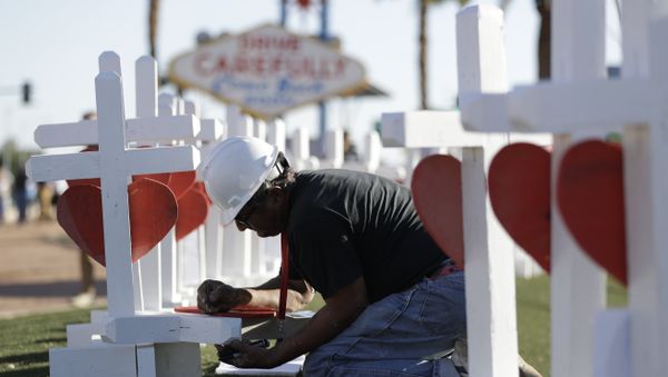 Greg Zanis writes the name of a victim of Sunday's mass shooting as he places crosses near the city's famous sign Thursday, Oct. 5, 2017, in Las Vegas. Greg Zanis writes the name of a victim of Sunday's mass shooting as he places crosses near the city's famous sign Thursday, Oct. 5, 2017, in Las Vegas. - Sputnik International