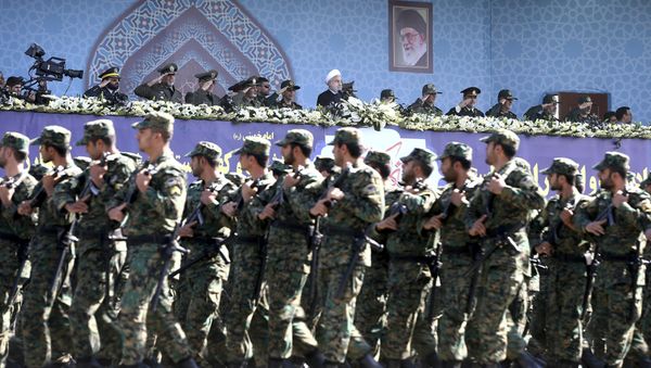 Iran's President Hassan Rouhani, top center, reviews army troops marching during the 37th anniversary of Iraq's 1980 invasion of Iran, in front of the shrine of the late revolutionary founder, Ayatollah Khomeini, just outside Tehran, Iran, Friday, Sept. 22, 2017 - Sputnik International