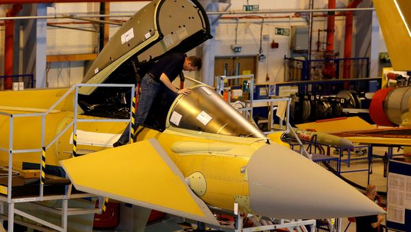 A member of staff works in the cockpit of an aircraft on the Eurofighter Typhoon production line at BAE systems Warton plant near Preston, Britain, September 7, 2012. - Sputnik International